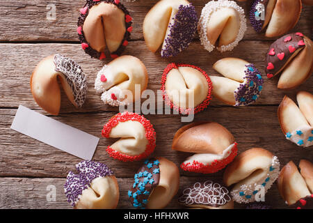 Beautiful fortune cookies decorated with candy sprinkles close-up on the table. horizontal view from above Stock Photo