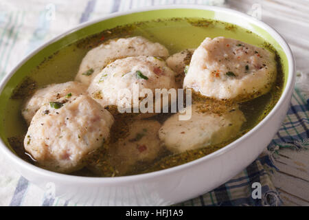 bread dumplings in a broth in a bowl close up. horizontal Stock Photo