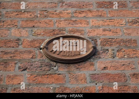 A brown wall mounted fire hydrant plaque in the Gun Quarter of Birmingham Stock Photo