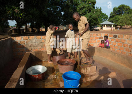 Gbderedou Baranama, Guinea, 2nd May 2015; This village and local area will be flooded by the dam. School boys fetching water before school starts. Stock Photo