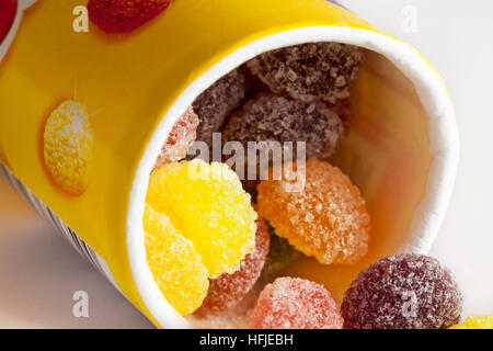 Jelly Tots sweets spilling from tube of Rowntrees Jelly Tots close up Stock Photo