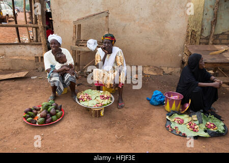 Koumban village, Guinea, 2nd May 2015; women selling avocados and cola nuts. Stock Photo
