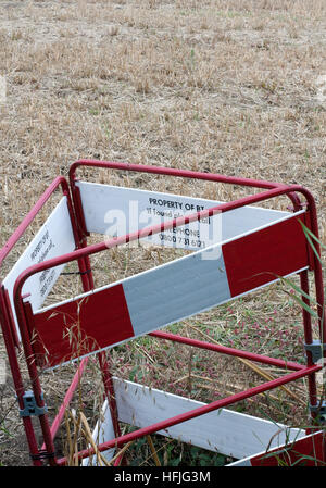 BT barrier around a forgotten hole in a field Stock Photo
