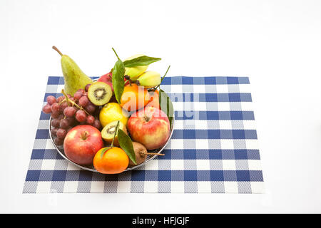 iron fruit basket with different fruits like apples, bananas, pears, grapes, kiwi Stock Photo