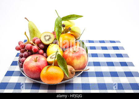 iron fruit basket with different fruits like apples, bananas, pears, grapes, kiwi Stock Photo