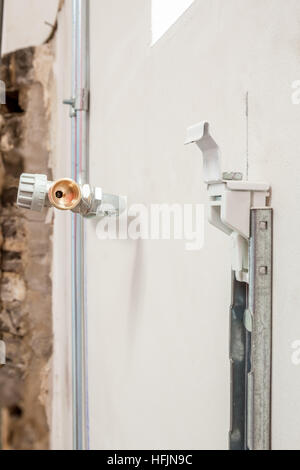 on the wall are the heating pipes already installed without radiator Stock Photo