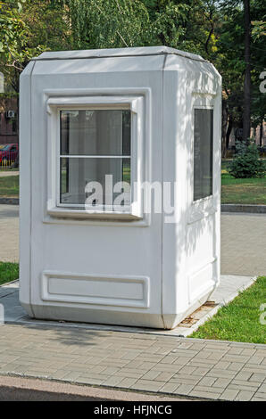 White guard box at the entrance to the park on a sunny spring day Stock Photo