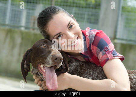 shelter keeper loves her residents Stock Photo