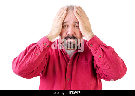 Depressed middle aged man with goatee beard and head in hands on white Stock Photo