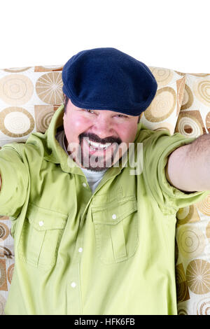 Half body portrait of smiling man in armchair taking selfie with white background and copy space Stock Photo