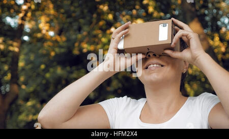 Exploring virtual reality in cardboard VR glasses Stock Photo