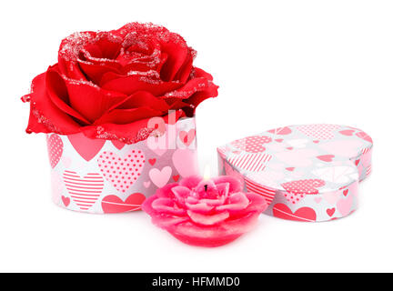 Red rose, candle and gift box on white background. Stock Photo