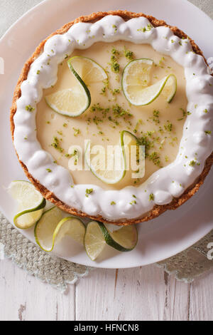 key lime pie with whipped cream close-up on a plate. vertical top view Stock Photo