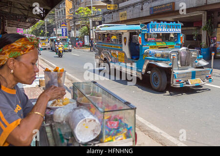 Jeepney service on the street in city centre, Manila, Philippines Stock Photo