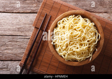 Asian ramen noodles in wooden bowl on the table. horizontal view from above Stock Photo