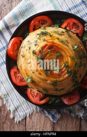 French timbale of pasta with cheese and vegetables close-up on a plate. vertical top view Stock Photo