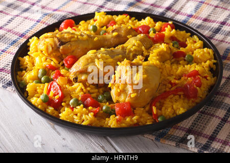 Spanish paella with chicken and vegetables close up on a plate. horizontal Stock Photo