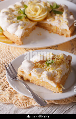 Sliced lemon cake with meringue closeup. vertical Stock Photo