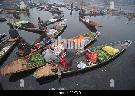 India. 31st Dec, 2016. A Kashmiri boatman (c) sells vegeables at the floating vegetable market in the interiors of famed Dal Lake in Srinagar, the summer capital of Indian controlled Kashmir on December 31, 2016. Vegetables sold in the floating market are supplied to many parts of Srinagar across the Kashmir. Selling vegetables has been the major source of income for the inhabitants of interiors of Dal Lake. © Faisal Khan/Pacific Press/Alamy Live News Stock Photo