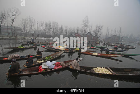 India. 31st Dec, 2016. Kashmiri Boatmen wait for customers as they sell vegetables at the floating vegetable market in the interiors of famed Dal Lake in Srinagar, the summer capital of Indian controlled Kashmir on December 31, 2016. Vegetables sold in the floating market are supplied to many parts of Srinagar across the Kashmir. Selling vegetables has been the major source of income for the inhabitants of interiors of Dal Lake. © Faisal Khan/Pacific Press/Alamy Live News Stock Photo