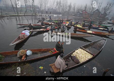 India. 31st Dec, 2016. Kashmiri Boatmen wait for customers as they sell vegetables at the floating vegetable market in the interiors of famed Dal Lake in Srinagar, the summer capital of Indian controlled Kashmir on December 31, 2016. Vegetables sold in the floating market are supplied to many parts of Srinagar across the Kashmir. Selling vegetables has been the major source of income for the inhabitants of interiors of Dal Lake. © Faisal Khan/Pacific Press/Alamy Live News Stock Photo