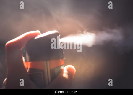 Photograph of a human hand holding an atomizer Stock Photo