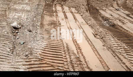 Bulldozer tracks on a surface of brown and gray sand Stock Photo