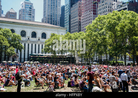 New York City,NY NYC Manhattan,Midtown,Bryant Park,public,Broadway in Bryant Park,concert,free performance,audience,lunch crowd,trees,library,NY160722 Stock Photo