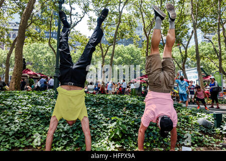 New York City,NY NYC,Manhattan,Midtown,Bryant Park,public park,upper terrace,adult,adults,man men male,doing handstand,visitors travel traveling tour Stock Photo