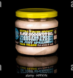 Fair Trade Extra Virgin Organic Raw Coconut Oil on a black background Stock Photo