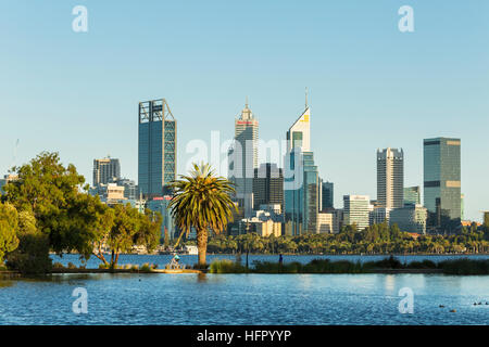 View across St James Mitchell Park and the Swan River to the city skyline at dawn, Perth, Western Australia, Australia