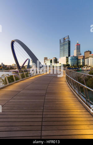 Twilight view along the Elizabeth Quay pedestrian bridge to the city skyline beyond, Perth, Western Australia, Australia Stock Photo