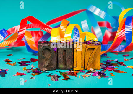 New Year 2017 in vintage letterpress typeset blocks and party confetti and ribbon Stock Photo