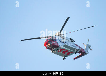 A Sikorsky S-92A HM Coastguard SAR Helicopter G-MCGY operated by Bristol Helicopters flies overhead on the North Cornwall coast, England, UK. Stock Photo