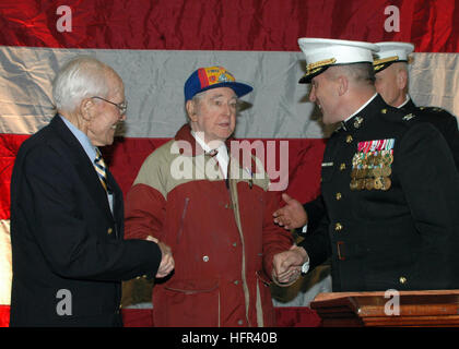 060323-N-6403R-064 Atlantic Ocean (March 23, 2006) - Mr. John Foley is presented a Purple Heart for injuries received during the battle of Iwo Jima by Commanding Officer 24th Marine Expeditionary Unit Marine Col. Johnson Ronald, and retired Marine Col. Frank Caldwell aboard USS Iwo Jima (LHD 7). More than 125 veterans also attend a Sunset Reception aboard Iwo Jima. U.S. Navy photo by PhotographerÕs Mate Airman Joshua Rodriguez (RELEASED) US Navy 060323-N-6403R-064 Mr. John Foley is presented a Purple Heart for injuries received during the battle of Iwo Jima by Commanding Officer 24th Marine Ex Stock Photo