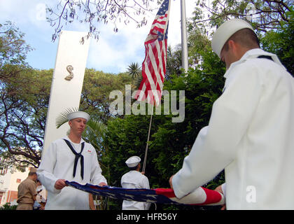 060425-N-0879R-001 Pearl Harbor, Hawaii (April 25, 2006) - Sailors assigned to Submarine Force, U.S. Pacific Fleet raise U.S. flags over the World War II Submarine Memorial at Pearl Harbor, Hawaii. Commander Submarine Force, U.S. Pacific Fleet Rear Adm. Jeffrey B. Cassias, will present the flags to family members of the crew of USS Lagarto during a memorial service at the Wisconsin Maritime Museum in Manitowoc, Wisconsin. The submarine, which was built in Manitowoc, was lost in World War II just months before the end of the war. U.S. photo by Chief Journalist David Rush (RELEASED) US Navy 0604 Stock Photo