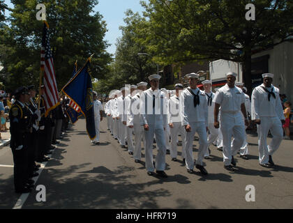 060529-N-7365V-108  New York (May 29, 2006) - Sailors assigned to the amphibious assault ship, USS Kearsarge (LHD 3) perform an 'eyes right' manuever as they march past the American flag held by Pelham Police Officers during the annual Pelham Memorial Day parade held during Fleet Week 2006. Pelham is the oldest town in Westchester County. Established in 1654. Fleet Week has been sponsored by New York City since 1984 in celebration of the United States sea service. The annual event provides an opportunity for citizens of New York City and the surrounding Tri-State area to meet Sailors and Marin Stock Photo