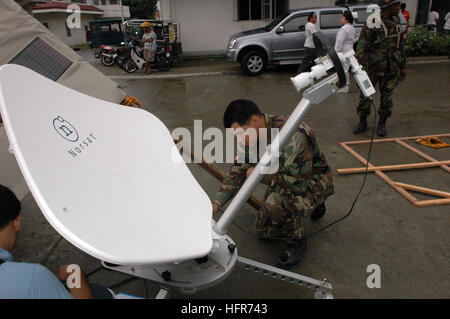 060601-N-9076B-012 Zamboanga, Philippines (June 1, 2006) - Navy Petty Officer 2nd Class Michael Orta of Los Angeles assembles a high-frequency satellite used for communications at Zamboanga Medical Center during the Military Sealift Command (MSC) Hospital ship USNS MercyÕs (T-AH 19) visit to the city on a scheduled humanitarian visit.  The satellite can be set up virtually anywhere and deliver high-speed Internet and telephone service. Mercy is on a five-month deployment to South Asia, Southeast Asia, and the Pacific Islands. The medical crew aboard Mercy will provide general and ophthalmology Stock Photo