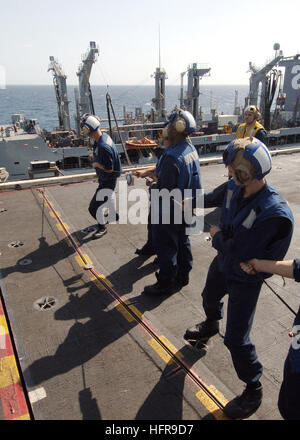 060828-N-6293B-065  Arabian Sea (Aug. 28, 2006) Ð Crew members aboard the nuclear-powered aircraft carrier USS Enterprise (CVN 65), hold the phone and distance line necessary for continuous ship-to-ship communication during replenishment-at-sea (RAS) operations with the Military Sealift Command (MSC) combat stores ship USNS Niagara Falls (T-AFS 3). The Enterprise Carrier Strike Group is currently on a scheduled six-month deployment in support of the Global War on Terrorism. U.S. Navy photo by Mass Communication Specialist 3rd Class Marcel A. Barbeau (RELEASED) US Navy 060828-N-6293B-065 Crew m Stock Photo