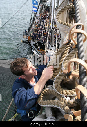 US Navy Seaman Douses The Flying Jib On Bowsprit Aboard USS us-navy-seaman-douses-the-flying-jib-on-bowsprit-aboard-uss