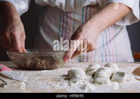 Two hands making meat dumplings. Stock Photo