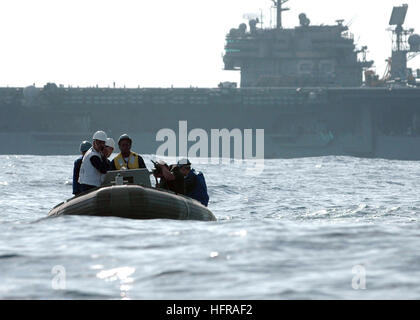 061020-N-1332Y-195 Pacific Ocean (Oct. 20, 2006) - Sailors from USS Kitty Hawk (CV 63) approach 'Oscar', a man overboard dummy, during training. Search and rescue (SAR) training is performed throughout the year to allow SAR swimmers the chance to practice various techniques. The training also provides new deck department Sailors with a chance to practice small-boat operations. U.S. Navy photo by Mass Communication Specialist Seaman Adam York (RELEASED) US Navy 061020-N-1332Y-195 Sailors from USS Kitty Hawk (CV 63) approach Oscar, a man overboard mannequin Stock Photo