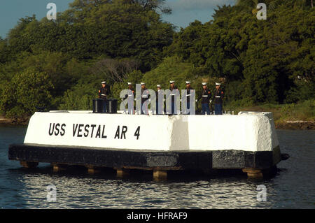 041207-N-6775N-102 Pearl Harbor, Hawaii (Dec. 7, 2004) - U.S. Marines, assigned to Marine Aircraft Group Two Four (MAG-24), stand at parade rest prior to a twenty-one gun salute on the USS Vestal mooring quay. Vestal, a repair ship, was moored outboard of the battleship USS Arizona during the attack on Pearl Harbor. She was hit by two bombs and further damaged when Arizona's forward magazines exploded. Repaired over the next few months, she was transferred to the South Pacific in August 1942, where she mended many combat-damaged ships during difficult times of the Guadalcanal and Central Solom Stock Photo