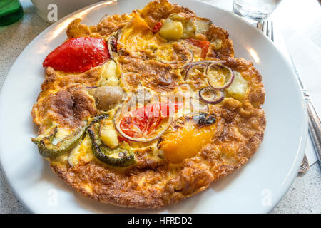 Spanish Omelette or Tortilla Espagnol made with potatoes peppers green beans and onions. Stock Photo
