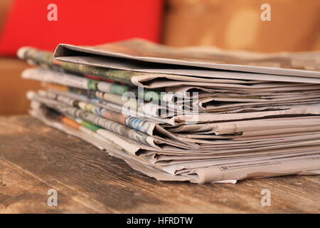 Newspapers on wooden table Stock Photo