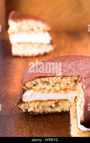 Macro view of chocolate cookies with milk souffle on a brown background with a shallow depth of field and blurred background Stock Photo