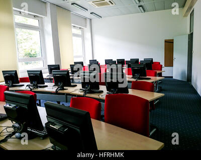 Empty schoolroom with many computers, soft focus Stock Photo