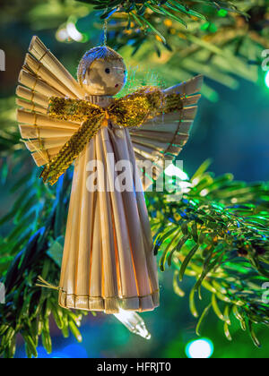 Straw Christmas angel hanging on christmas tree Stock Photo