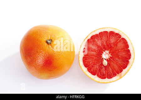 Ruby Red Grapefruits (Citrus x paradisi), whole and halved Stock Photo