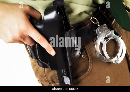Detail, female police officer with handcuffs and gun holster Stock Photo